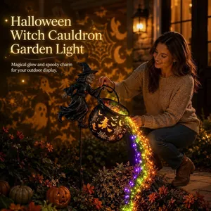 Detailed view of the Halloween witch cauldron garden light with magical glowing string lights.