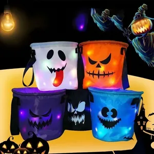 Detailed view of colorful LED glowing Halloween candy baskets with ghost faces.
