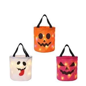 Set of 3 Halloween glow-in-the-dark candy baskets with LED lights and festive faces.