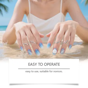 Blue gradient beach theme press-on nails with shell and starfish patterns on hand