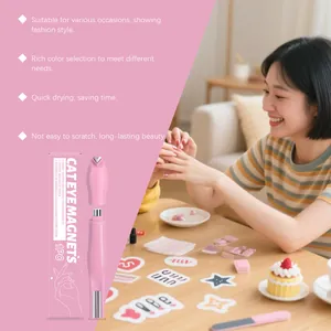 Woman using pink cat eye nail magnet tool in a cozy home setting with nail art accessories.