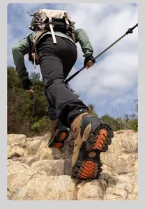 SkyPilot waterproof hiking boots with non-slip sole shown in an outdoor climbing scene.