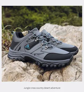 Professional grey waterproof men's hiking shoes on a rock in a jungle setting