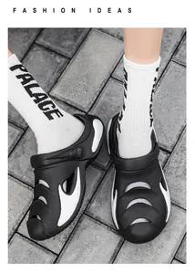 Close-up of black and white men's beach clogs with flame design and breathable holes.