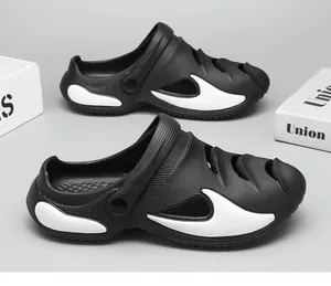 Detailed side view of stylish black and white beach clogs with breathable hollow design