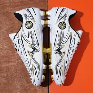 Professional white football shoes with gold graphics and cleats for youth training.