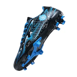 Professional firm ground soccer cleats featuring a blue wave pattern and high traction studs