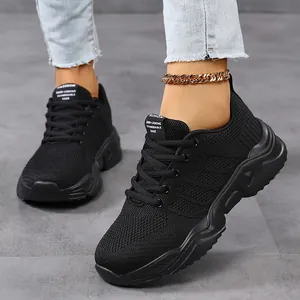 Close-up of black breathable knit sneakers featuring a thick textured sole and mesh fabric