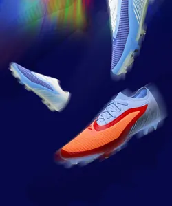 Dynamic motion blur detail of professional seamless flyknit soccer cleats on dark blue