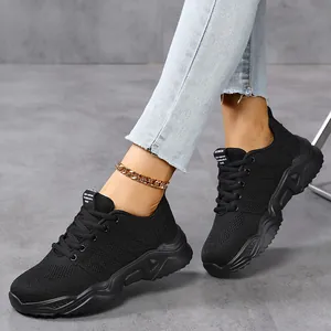 Close-up view of black breathable knit sneakers worn by a model for summer casual wear
