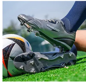 Close-up view of breathable soccer cleats showing cleat studs and grey upper.
