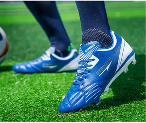 Detailed close-up of vibrant blue and white breathable soccer cleats on green turf field
