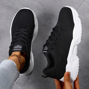 Macro detail of breathable black flyknit mesh and chunky white sole on fashion sneakers
