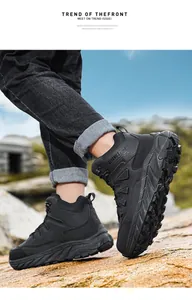 Macro view of durable black high-top hiking boots for outdoor camping on rocky terrain