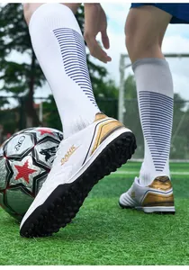 White and gold TF turf soccer shoes with textured upper for student match training