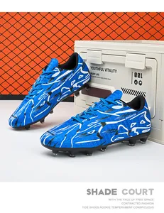 Blue and white patterned low-top soccer cleats designed for training on artificial turf