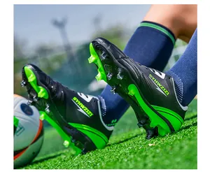 Dynamic action shot of professional black and green soccer cleats on grass field