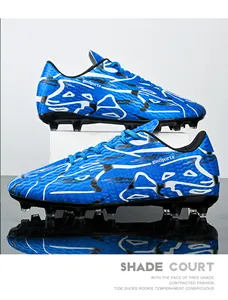 Side profile view of blue soccer cleats showing textured upper and durable long studs