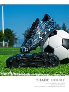 Detailed view of low-top soccer shoes with vibrant blue lighting pattern on green grass