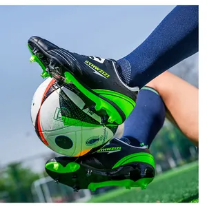 Action shot of breathable soccer cleats with studs on professional turf field