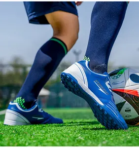 Detailed view of blue and white breathable soccer cleats featuring durable studded outsoles