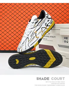 Detail of low-top soccer shoes with white upper and gold patterns on turf studs sole.