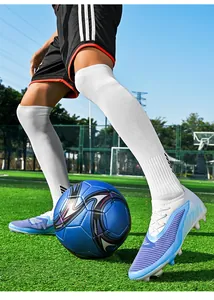 Detailed view of low-top flyknit soccer cleats in action on artificial grass turf.