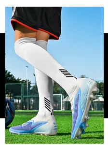 Close-up view of seamless flyknit soccer cleats designed for professional training on turf.
