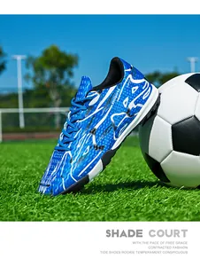 Blue turf soccer shoe with white patterns on a professional grass field