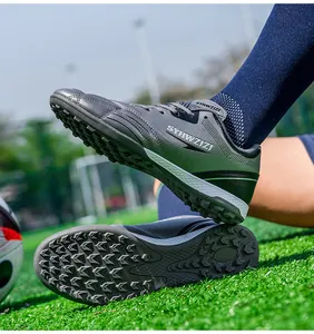 Detailed side and sole view of breathable green soccer shoes with turf cleats on field