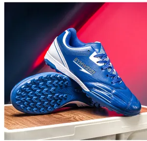 Blue TF turf soccer shoes with breathable upper and textured rubber studs