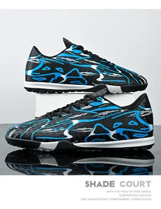 Detailed side view of blue and black turf soccer shoes with a unique patterned upper texture