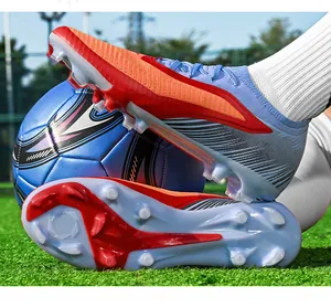 Close-up of professional firm ground soccer cleats with blue and red knit upper.