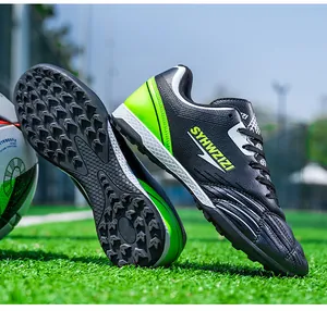 Detailed view of black and neon green turf soccer shoes showing the TF spike sole pattern