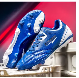 Close-up detail of blue youth soccer cleats showing the sole studs and texture