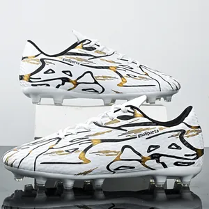 Professional low-top soccer shoes with black and gold graphics for artificial turf