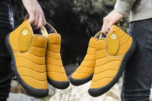 Detailed view of yellow quilted snow boots featuring warm plush lining and durable rubber sole