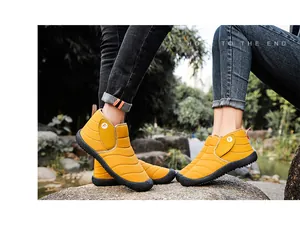 Detail of yellow winter snow boots with warm plush lining shown in an outdoor lifestyle setting