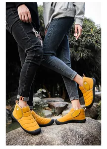Detail of yellow quilted outdoor snow boots with warm lining and anti-slip sole.
