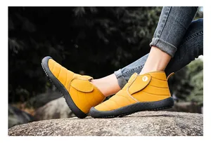 Detail view of yellow quilted outdoor winter boots with warm lining and non-slip soles.