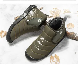 Durable olive green warm fleece-lined winter snow boots presented in an outdoor snow scene