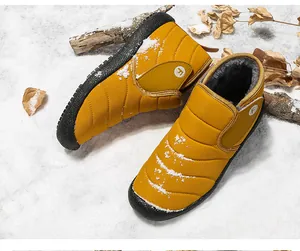 Vibrant yellow waterproof winter snow boots featuring warm fleece lining and non-slip rubber soles