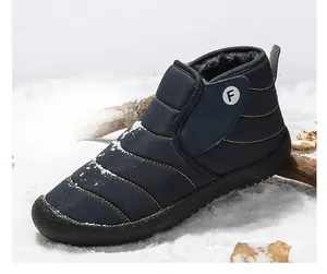 Detail view of navy blue quilted snow boots with warm fleece lining and yellow stitching