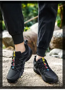 Detail shot of black men's hiking shoes with breathable mesh and colorful strap accents.