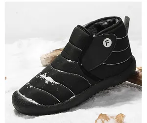 Detailed view of warm black snow boot with fur lining on snowy ground