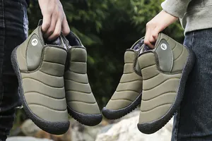 Close-up of olive green quilted winter snow boots with warm faux fur lining and non-slip sole