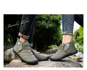 Close-up detail of couple wearing olive green quilted snow boots in an outdoor setting