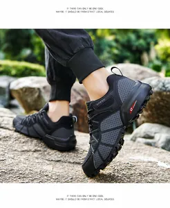 Side view of breathable men's hiking shoes with rugged outsole on rocky terrain
