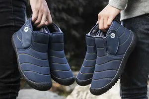 Detailed view of navy blue couple snow boots with thick plush lining for winter warmth