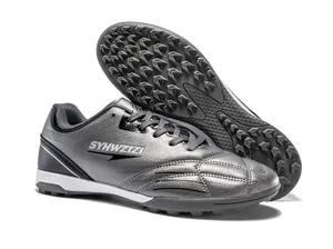 Breathable silver soccer cleats with textured metallic upper and durable turf outsole